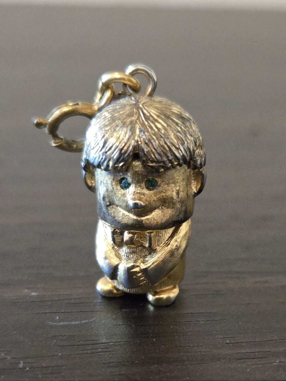 Vintage Monet gold-tone boy charm with green eyes